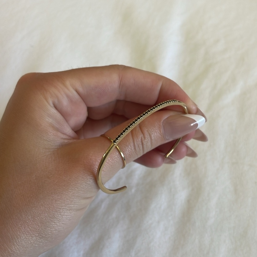Sole society gold bangle with black gem detailing